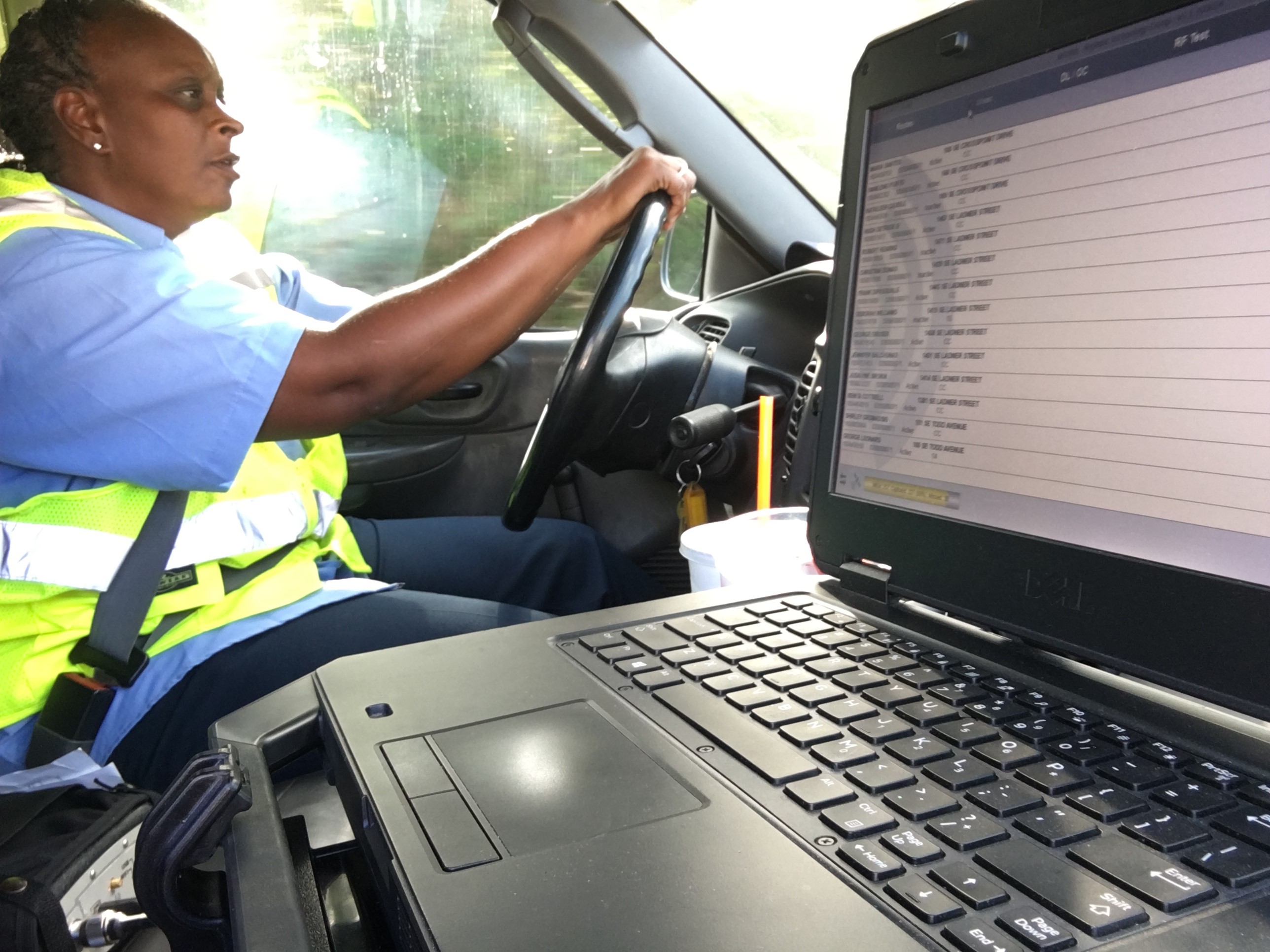 Employee driving truck capturing information from radio read meters using a laptop computer