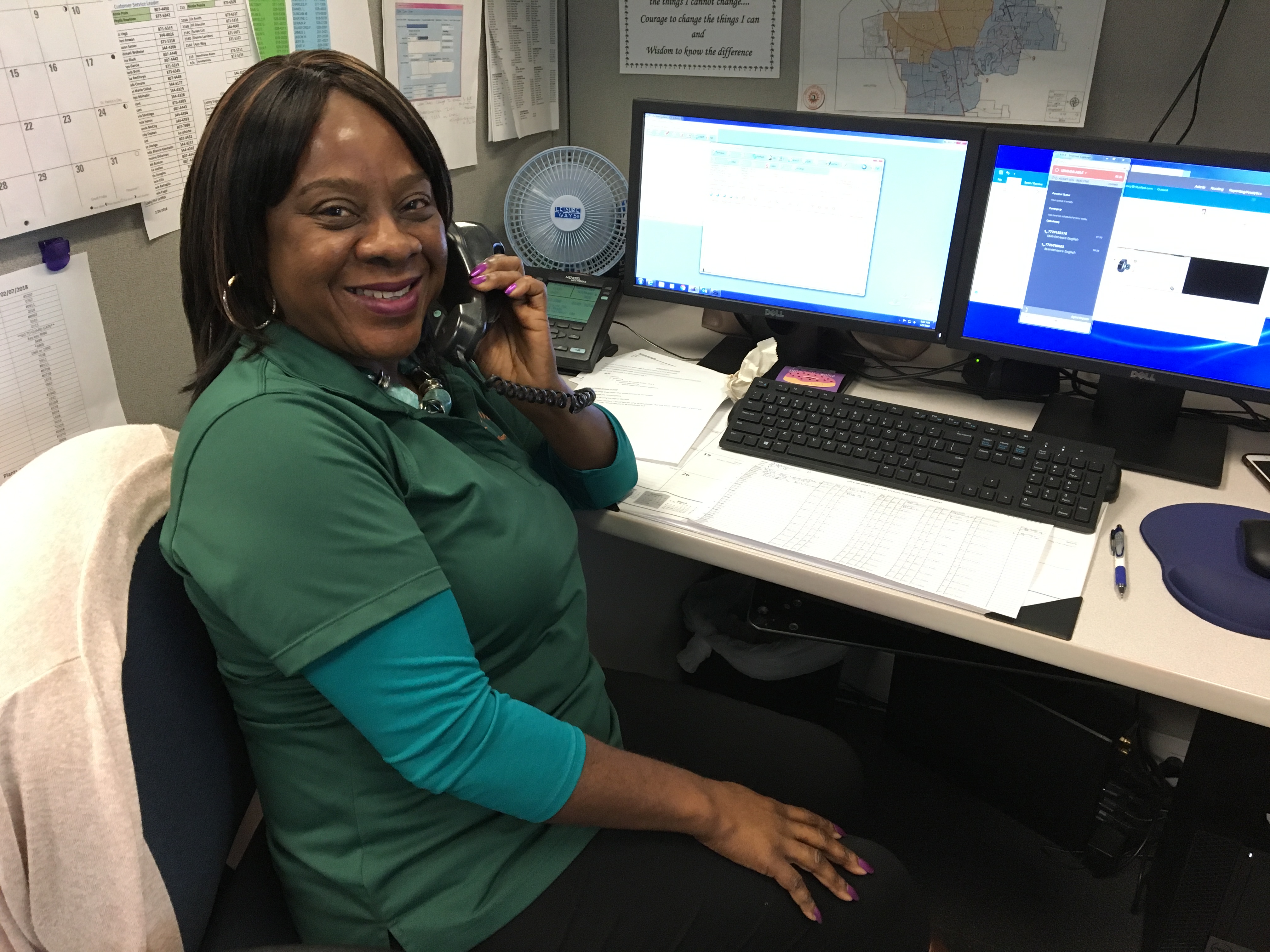 Customer Service Specialist smiling while speaking to a customer on the phone