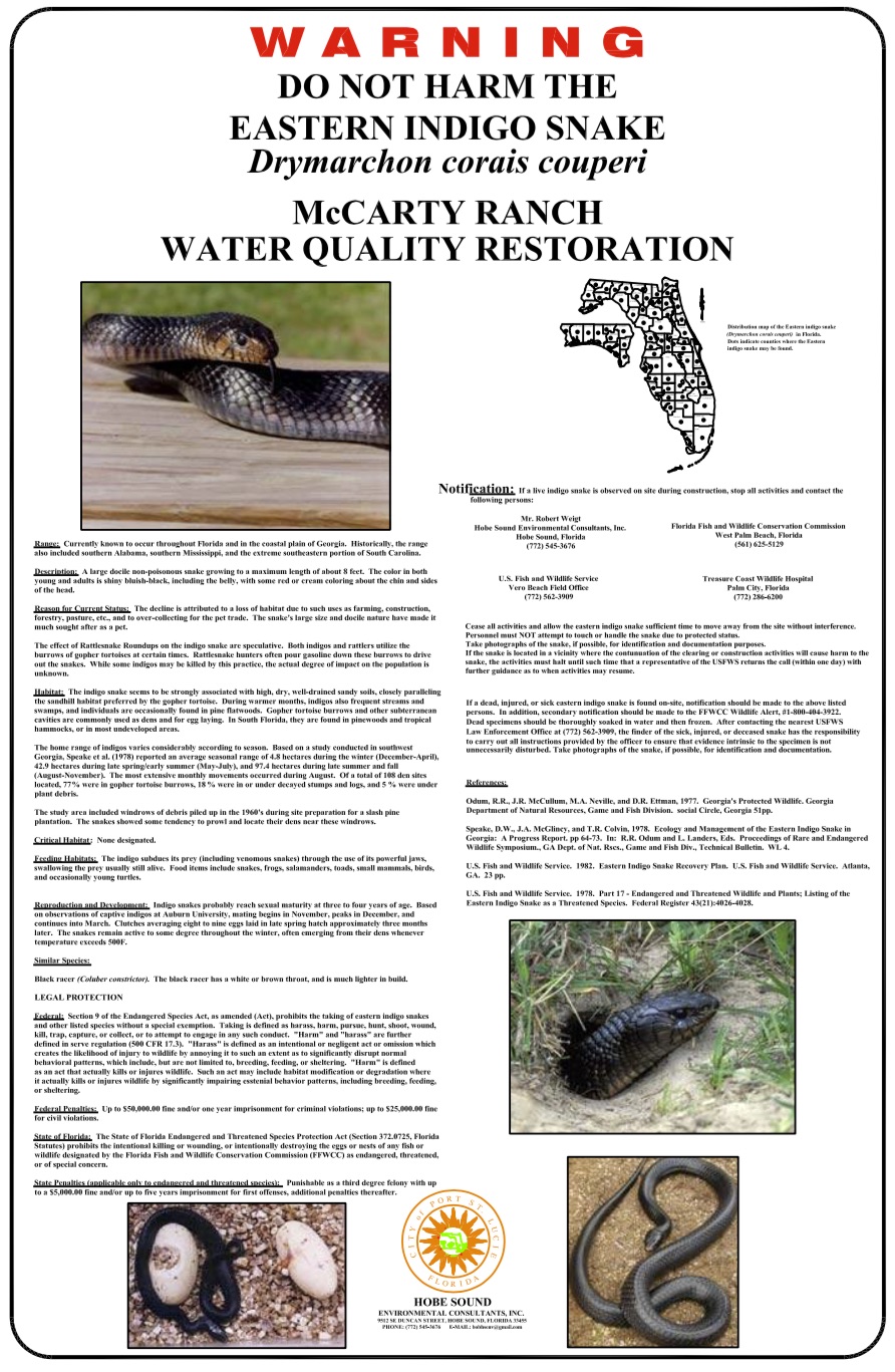 Warning sign with information about indigo snakes posted near rock habitat
