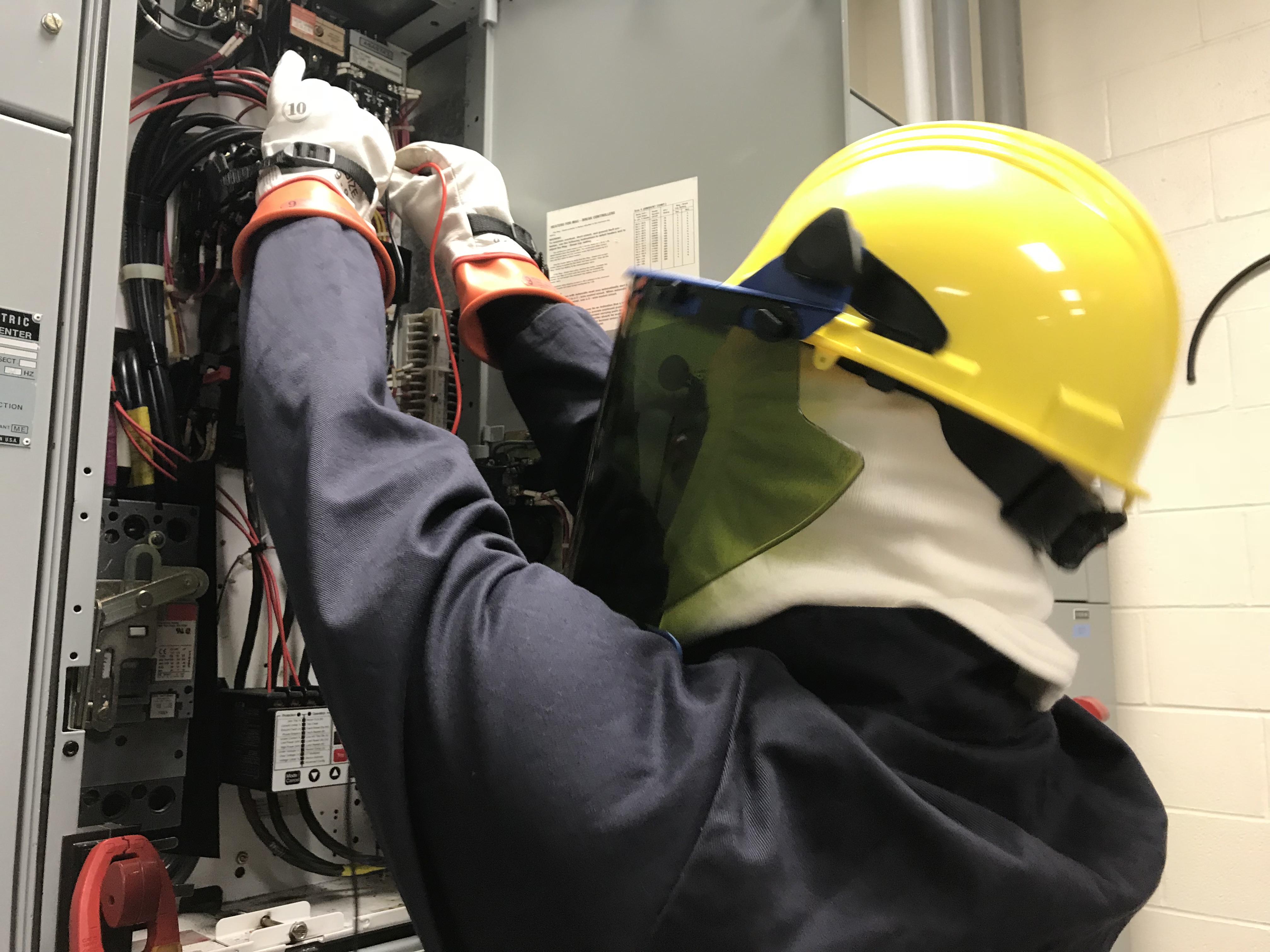 Electrician working on an electrical panel