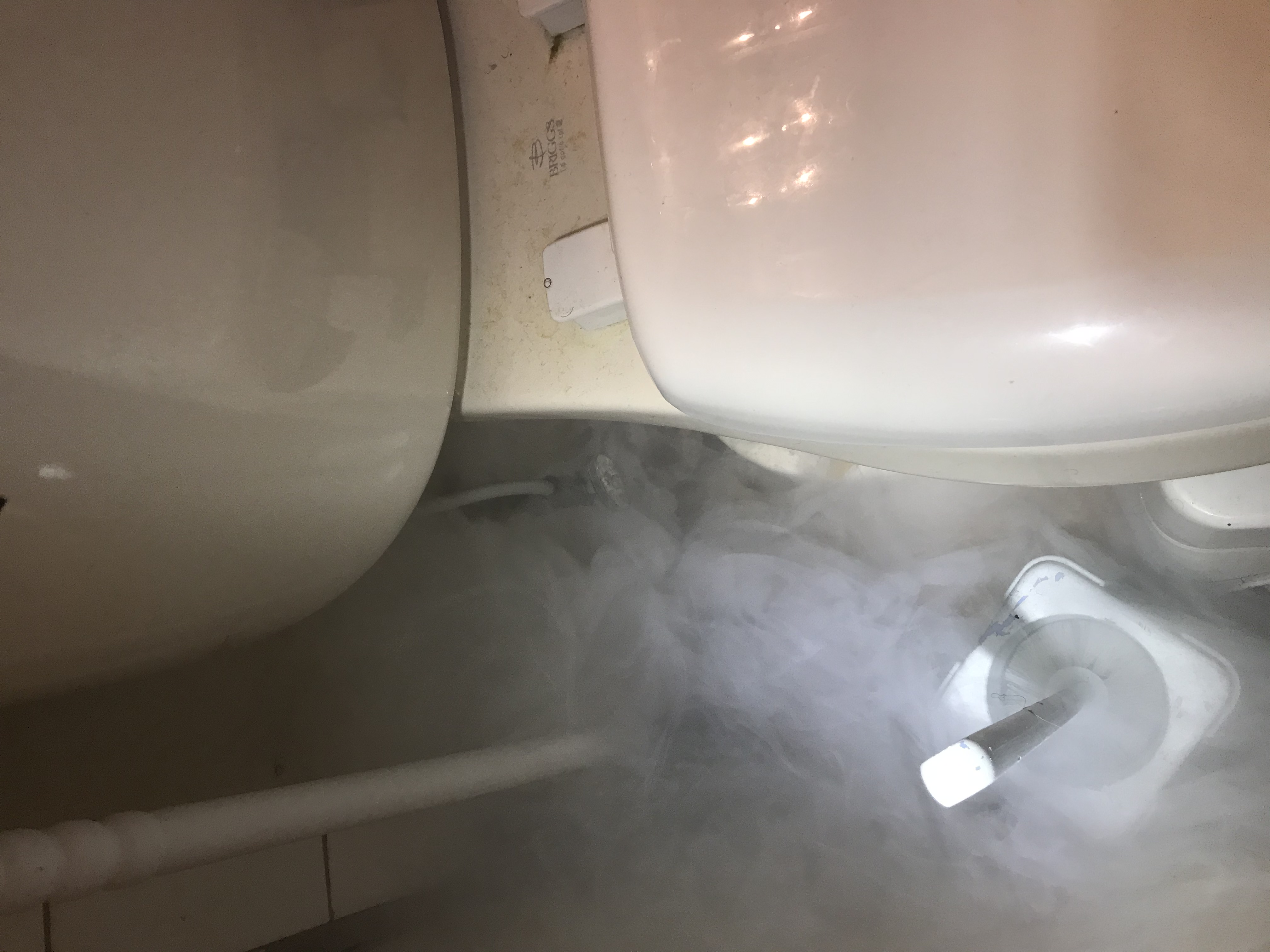 smoke rising from bottom of toilet